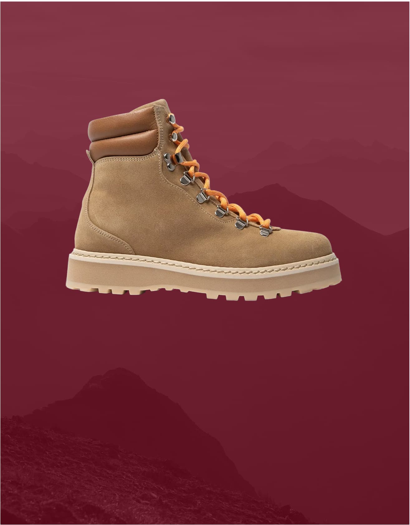 Beige shoes, displayed against a maroon background with faint mountain silhouettes.